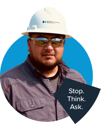 a man wearing a hard hat and sunglasses