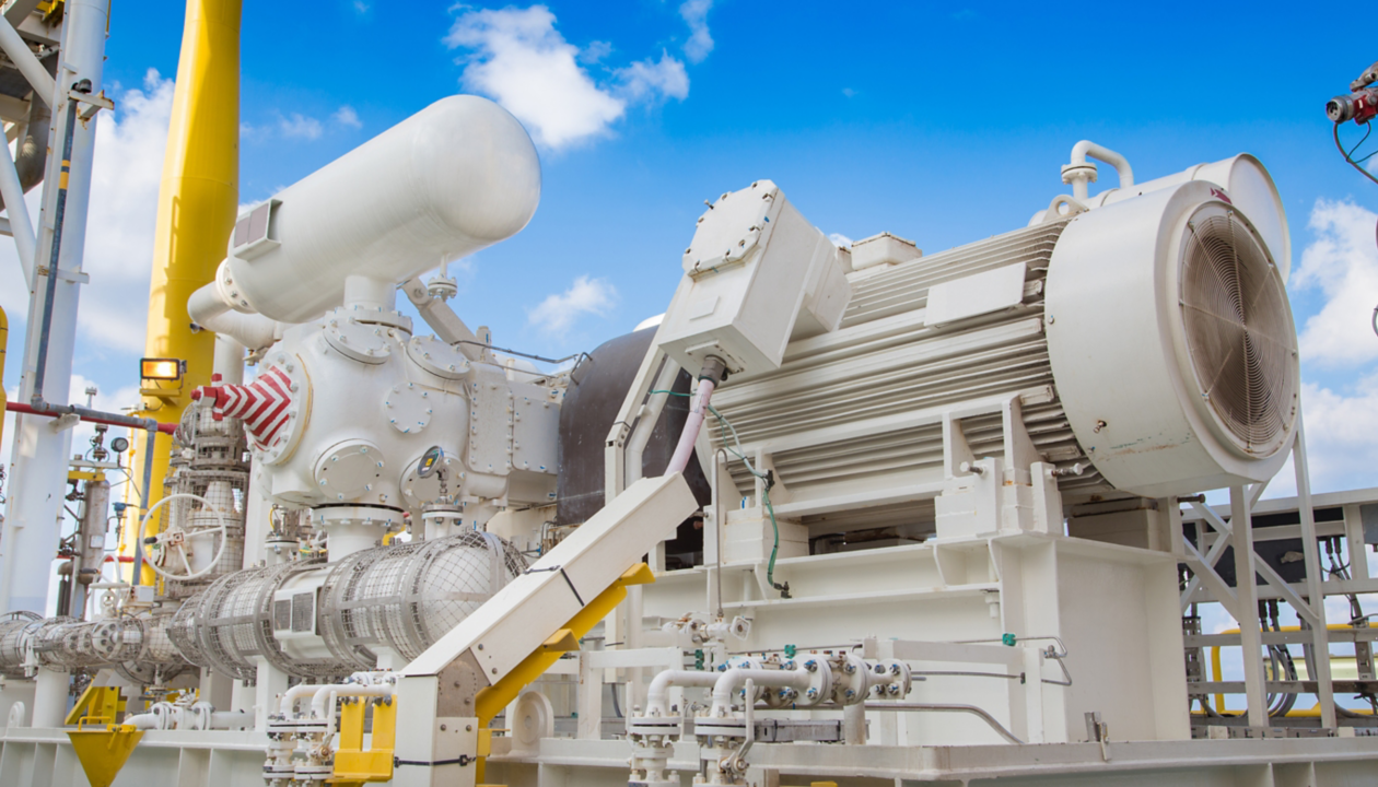 a large machine with pipes and a yellow pole