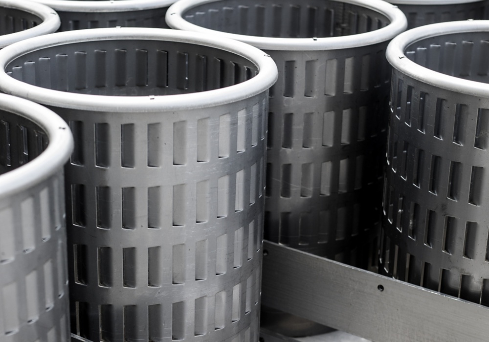 several metal containers on a conveyor belt