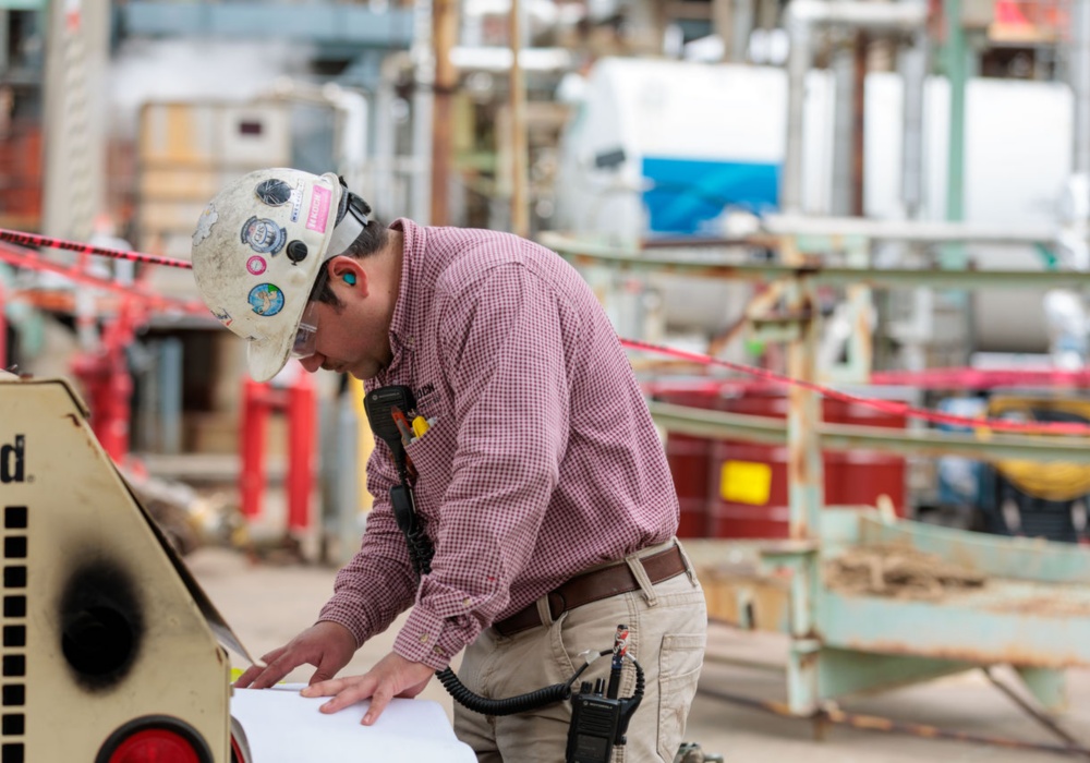 a man wearing a hard hat and glasses