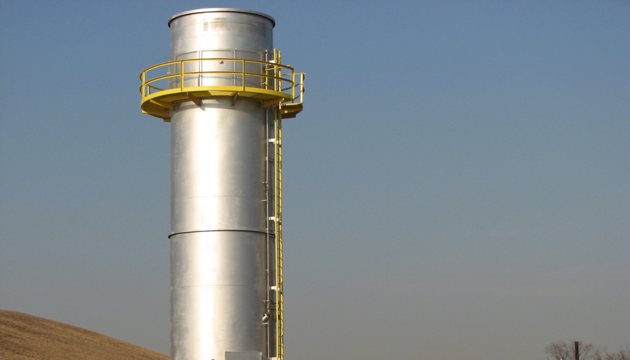 a large silver tower with yellow railing